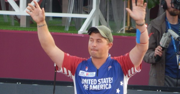 Brady Ellison of the United States raising both arms to the crowd at the 2019 Archery World Cup Final in Moscow