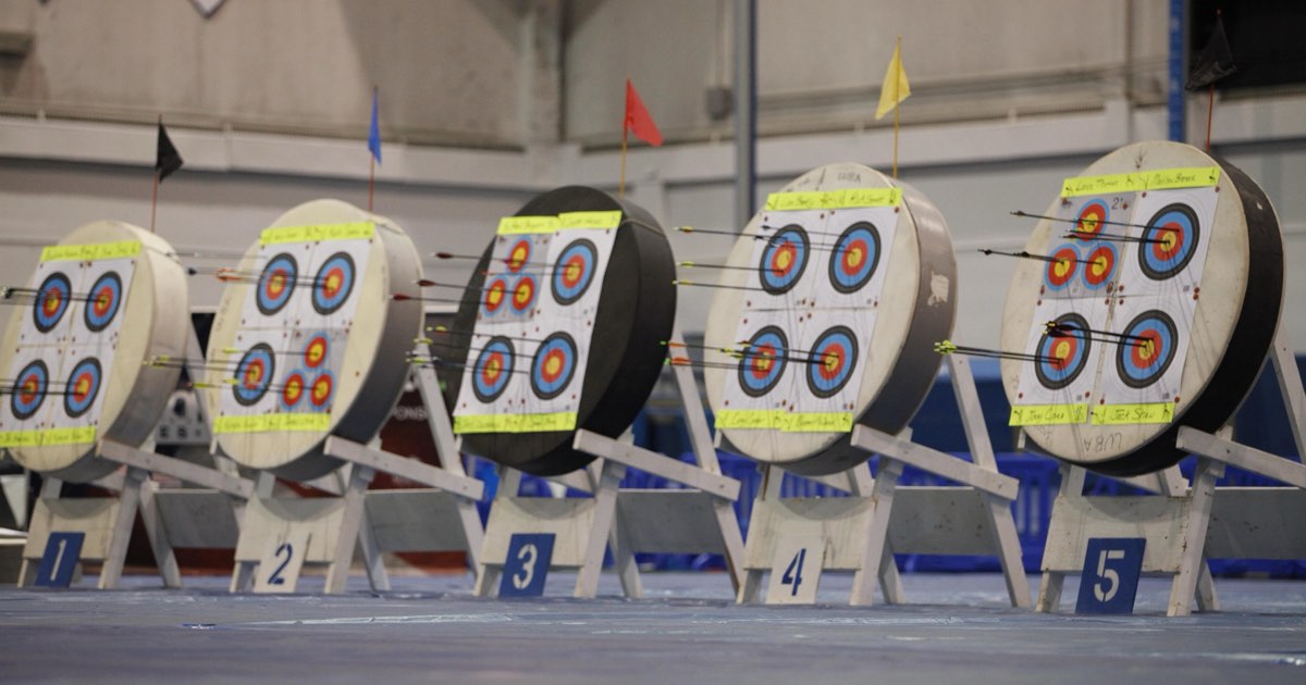 A row of numbered target bosses with multi-spot faces at an indoor training range
