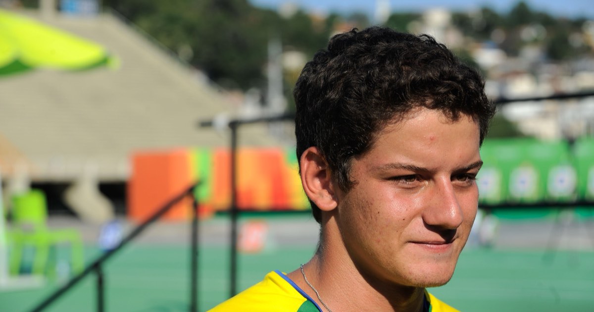 Portrait of Brazilian recurve archer Marcus D'Almeida in a yellow Brazil shirt at an archery venue