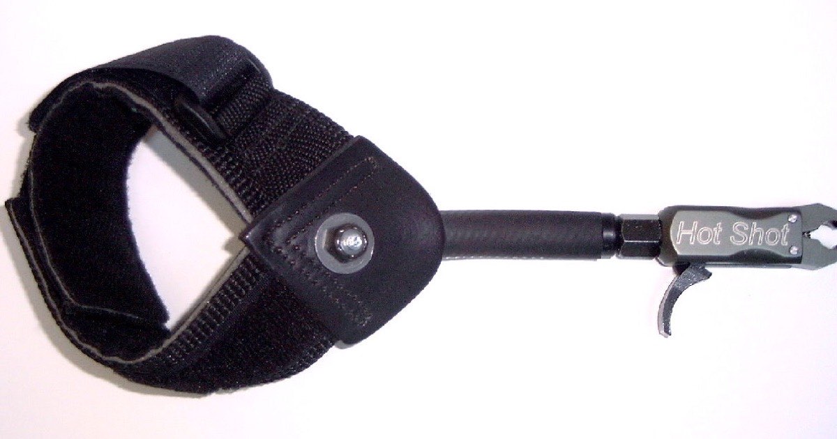 Wrist-strap mechanical release aid with a trigger and a jaw that holds the string loop